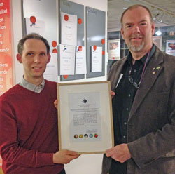 Magnus Persson tar emot ett diplom fr&aring;n Naturskyddsf&ouml;reningens Mathias Hellstr&ouml;m